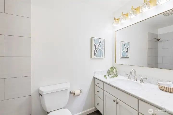 Upper level hall bath with full tub/shower shared by Bedrooms 1 and 2 Upper level hall bath with full tub/shower shared by Bedrooms 1 and 2
