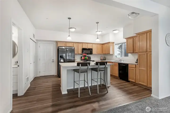 Kitchen with large island. Garage entrance to left of refrigerator. Kitchen with large island. Garage entrance to left of refrigerator.