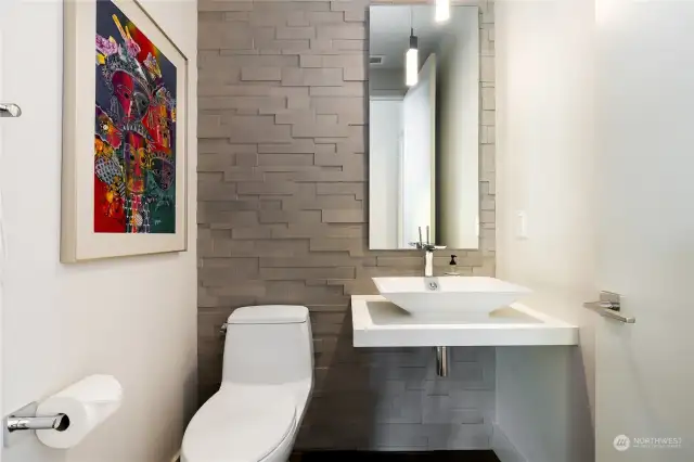 Powder room with architectural wall.