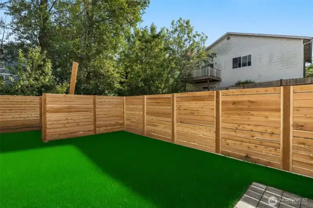 This photo has been edited to show the final look of the fenced backyard
