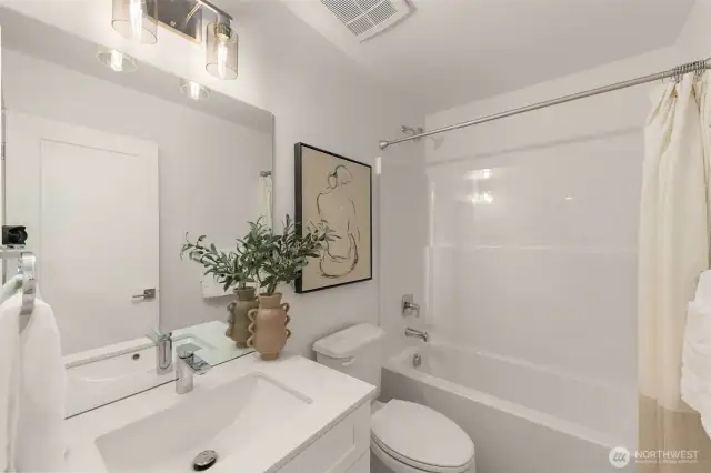 Step into a sleek and stylish bathroom featuring a modern vanity, timeless subway tiles, and a well-lit mirror that makes getting ready a breeze.