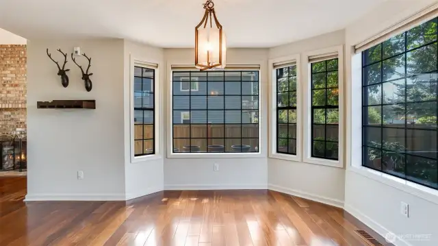 This view highlights the beautiful grid windows and a stylish light fixture, adding timeless character to the dining area.