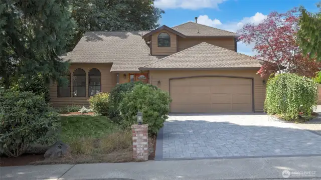 This home boasts an attached two-car garage, a stunning paver driveway, and a detached garage—perfect for extra vehicles, hobbies, or storage.