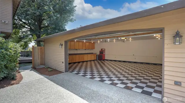 This detached garage features stylish checkered floors and great lighting— space is perfect for a workshop, home gym, or storing all your favorite toys.