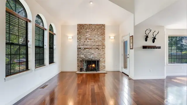 Cozy up by the rustic brick fireplace, side door leads to your backyard oasis!
