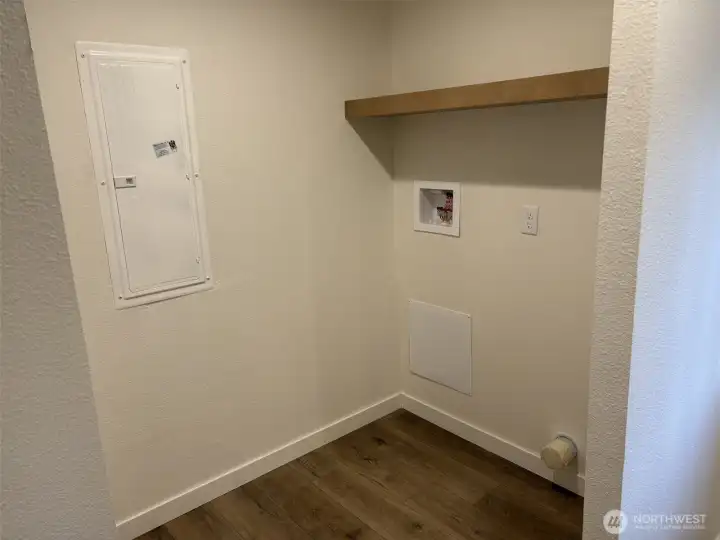 Laundry Room with electrical panel.