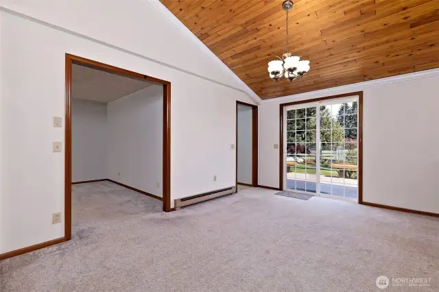Dining area with slider to back deck. First doorway to secondary living room. Second doorway leads to mudroom, 1/2 bath, laundry and attached 2-car garage.