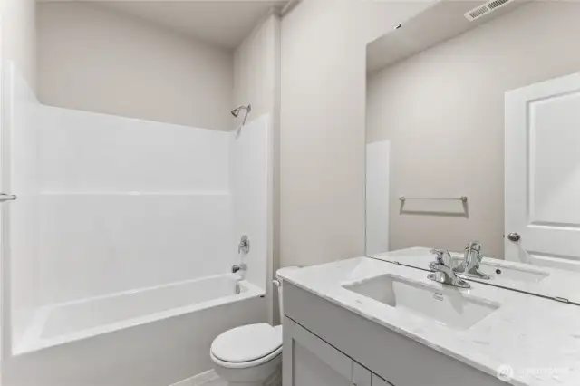 Attractive hall bathroom with deep tub.