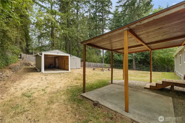 Covered patio and outbuildings for storage!