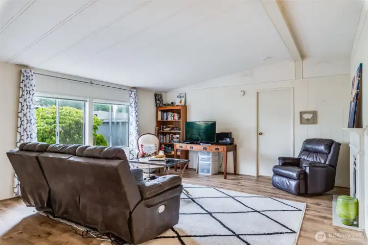 Bright living space filled with natural light, ideal for reading or relaxing.