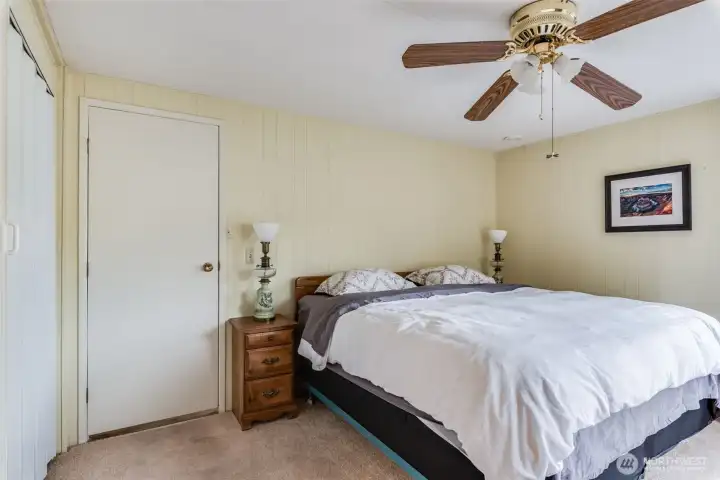 Primary bedroom offers comfort with a ceiling fan and generous space for relaxing.