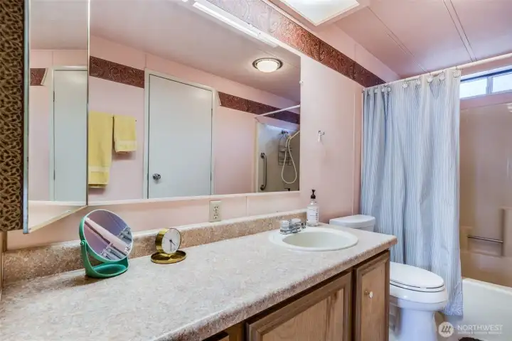 Large vanity with tons of counter & storage space plus an oversized mirror with bright lighting makes daily routines simple and comfortable.