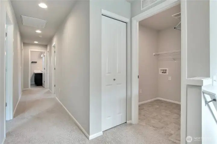 View from the upstairs landing down the hallway. To your right is the utility room and a linen closet. All bedrooms are up, and at the end of the hall is the kids/guest full bath.