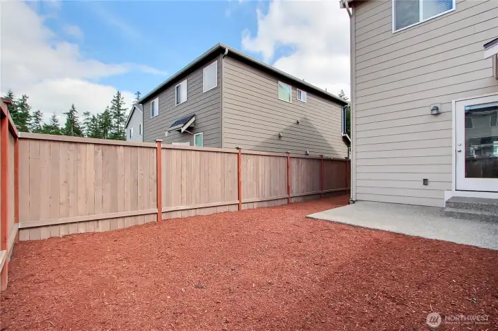 View of your backyard patio, back and side yards. Landscaping just refreshed, fully-fenced, talk about low maintenance!