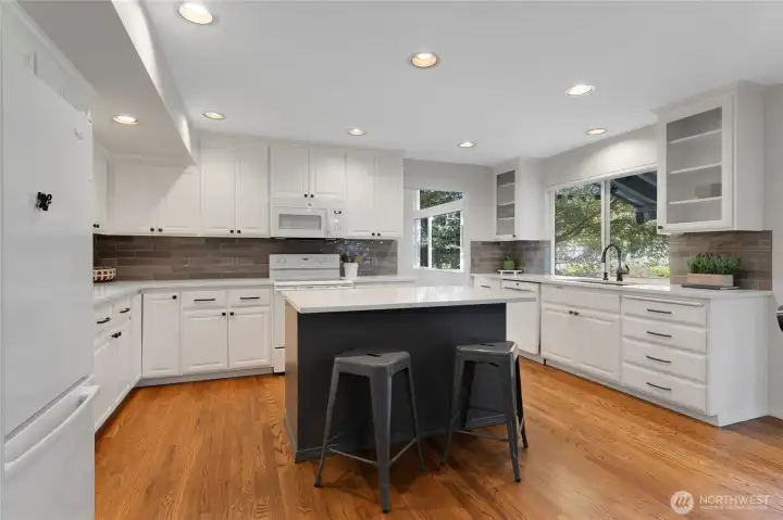 Kitchen with quartz counters and island.