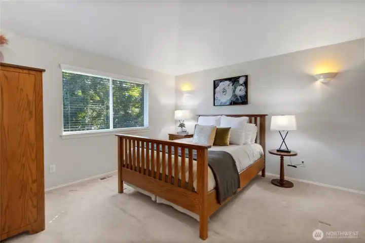 Upstairs primary room is spacious and faces back of the home.