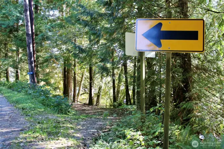 Driveway located next to yellow directional.