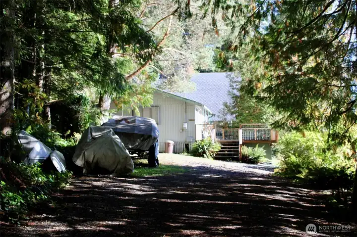 Long secluded driveway leads to the sunny waterfront lot.