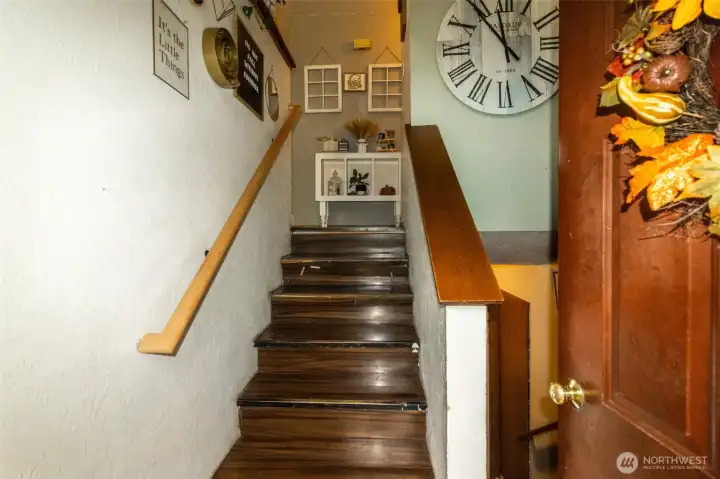 Split level. Upstairs leads to living room, kitchen, dining, and two bedrooms. Downstairs leads to two bonus rooms and utility/ 3/4 bath