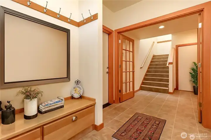 Front entrance with wide doors and tile floors.