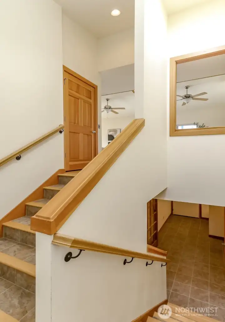Tile Staircase with Fir trim to upstairs door for elevator. Solid core raised panel doors.