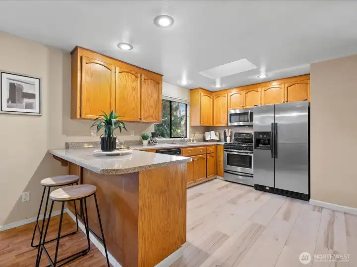 Loads of work space and cabinetry, stainless appliances, deep stainless sink, new vinyl plank floor in the kitchen.