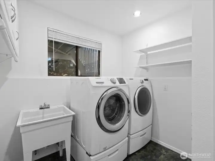 Great laundry room with utility sink. The washer and dryer stay with the home.