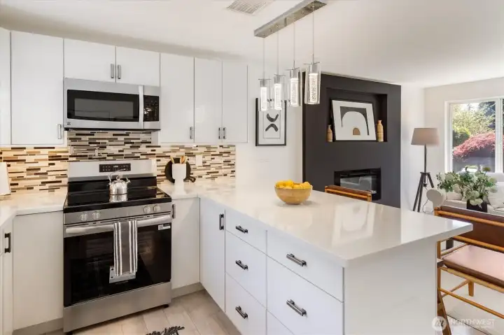 Updated kitchen with quartz countertops, custom cabinetry, and stainless appliances. Image from earlier listing in Sep 2025.