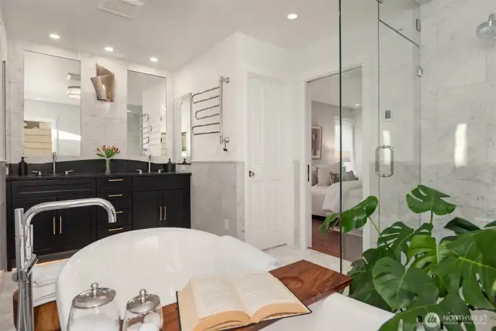 Primary Bedroom on this level is a spacious retreat with all the amenities needed for a relaxing and rejuvenating atmosphere.  Make life simple with lighted closet organizers. In-spa bath with glass enclosed steam shower, free standing bathtub, heated floors and towel rack, dual sinks and plenty of cabinet space. High quality Kohler fixtures, mosaic marble, pewter sconces, hand rubbed antique brass, dual Robern medicine cabinets.