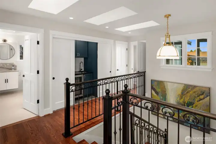 Stacked Bosch washer and dryer on this level add functionality and convenience while discreetly stowed next to the wet bar and refrigerator.  Skylights and picture windows throughout the home flood the interiors with natural light, creating a bright and uplifting atmosphere.