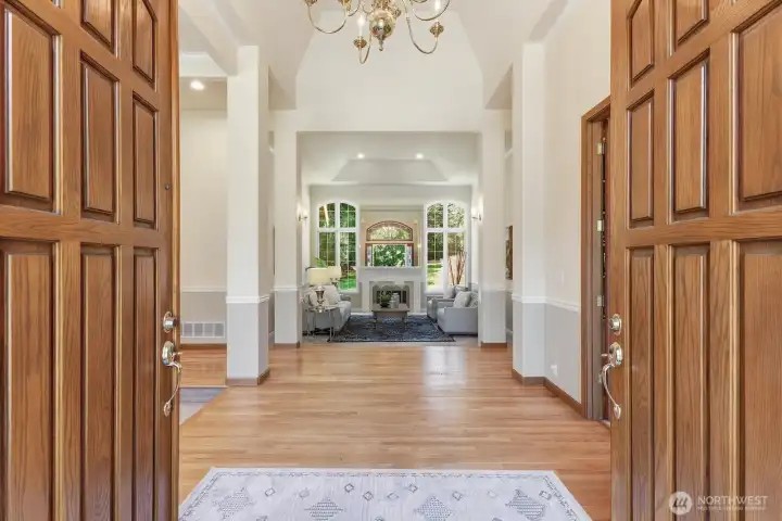 The expansive circular drive leads to the cedar lined covered front entryway with double doors opening into the inviting foyer.