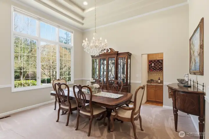 The formal dining room is similarly ornamented and features tall 18-foot ceilings and Venetian crystal chandelier. The butler’s pantry is off the dining room and features built-in cabinetry with a wine rack and granite slab counter.