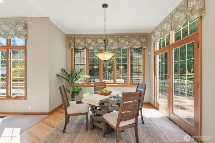 Informal dining is right off the kitchen overlooking the lush backyard.