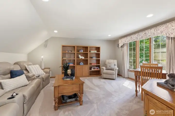 The bonus/media room with leather reclining chairs, 5.1 surround sound, hidden projector and drop down screen.