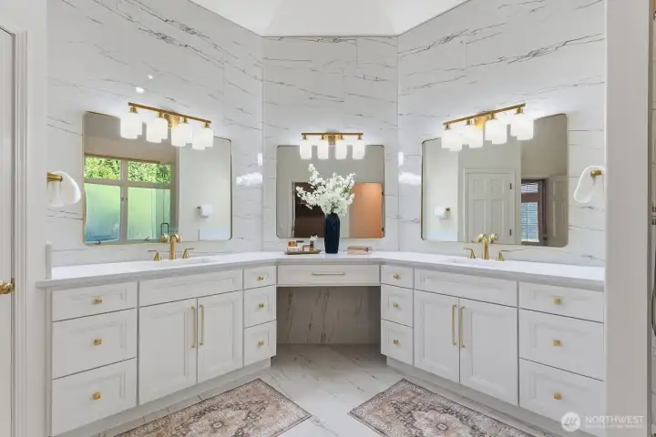 The all new ensuite bathroom is sure to delight with its designer large format tiled floor, custom quartz vanity with make up seating and extensive tiled wall behind designer mirrors.
