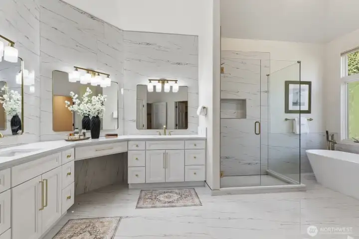 Free standing tub, large tiled shower and brushed gold fixtures.