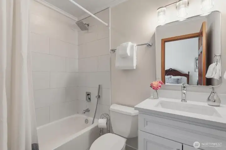 With 12x24 tiled floor, tiled tub/shower and new quartz vanity.