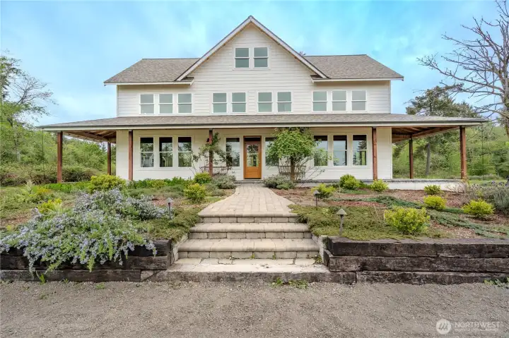 Main farmhouse faces east to bay views. Covered wraparound deck offers year round outdoor enjoyment