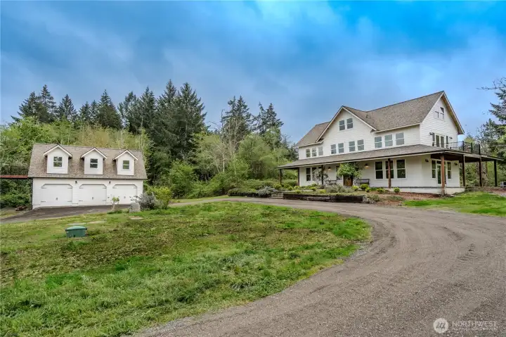 Farmhouse and detached garage.  Note the 2d level veranda.  Each primary suite has a walkout deck with territorial and bay views.