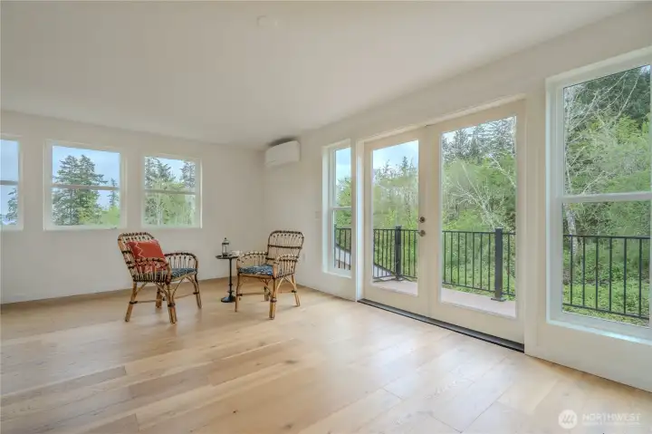 South primary suite retreat wrapped in windows where natural light defines the space morning to evening. French doors to Veranda views for quiet morning coffee and evening unwinding. Lovely bay ad territorial views