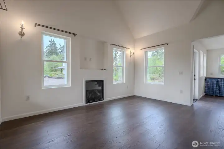 Main living area in granny cottage with propane fireplace and charming candle sconces