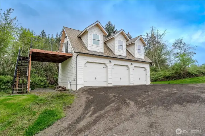 Detached 3 car garage with 2d level walkout deck faces east for sunrises over the water