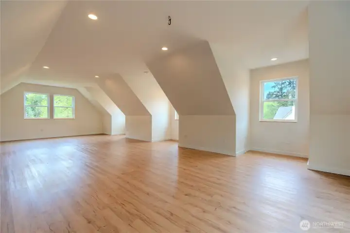 900 SF above garage bonus space light and bright with 3 dormers and walkout to amazing second level deck with water views