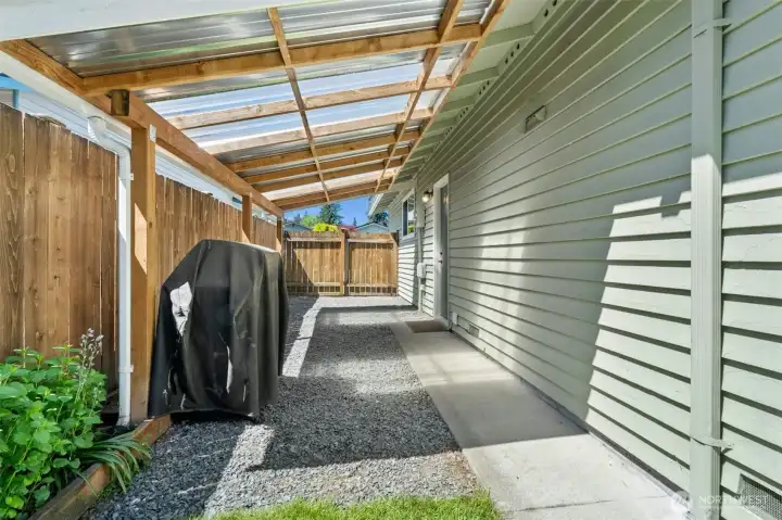 Covered side yard for all your projects. There's a door that leads into the 2-car garage.