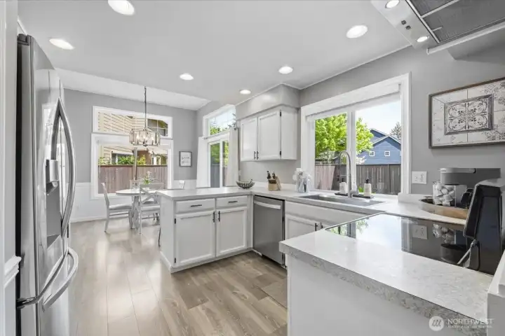 Oversized picture windows and slider allows for keeping an eye on backyard activity while bringing in tons of natural light.