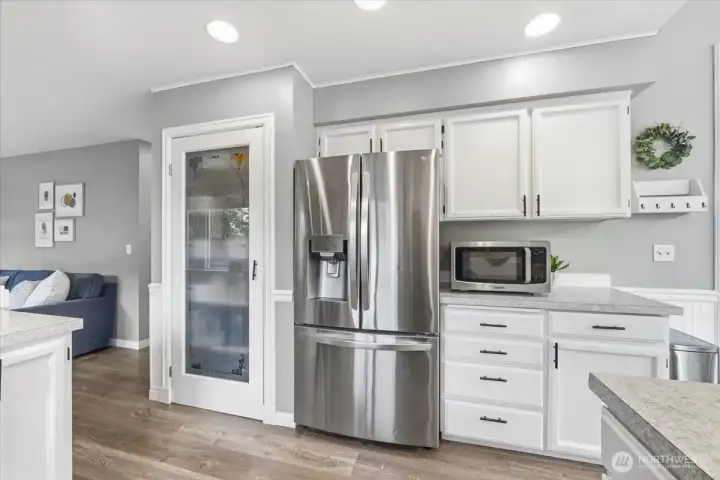Stainless appliances and pantry are special touches in this inviting kitchen!