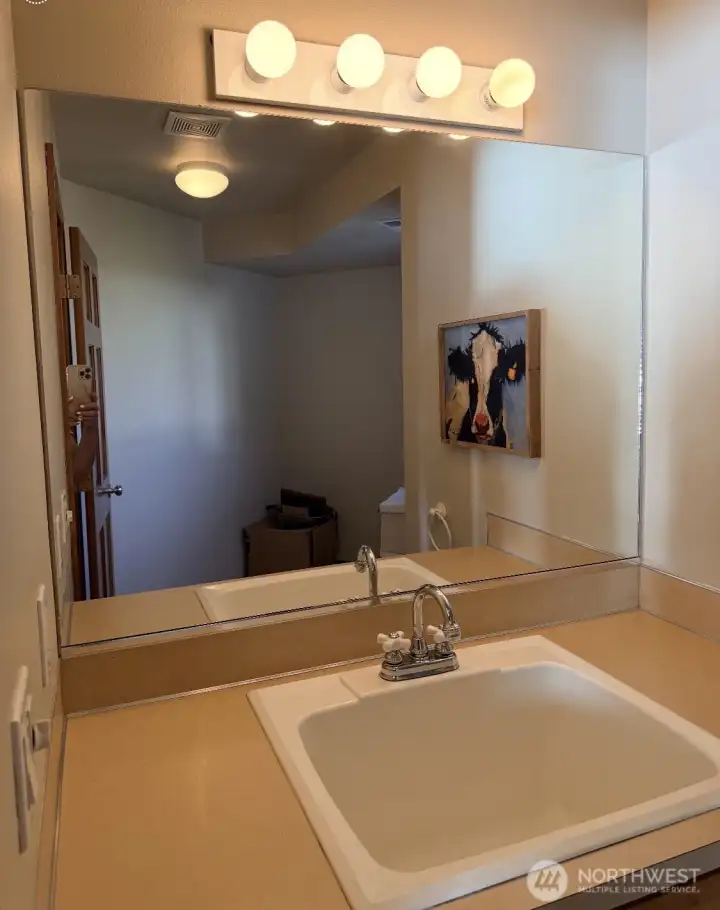 Current set up off of upper level closet/sink area. It is plumbed for a toilet and shower (buyer to verify).