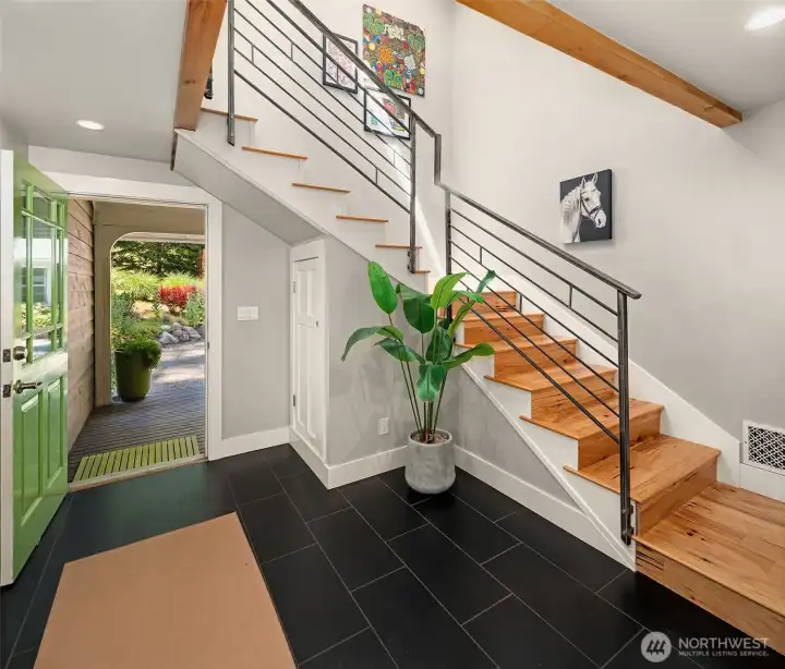 The entrance hall features custom steel handrail and ceramic tile flooring. The entrance hall features custom steel handrail and ceramic tile flooring.