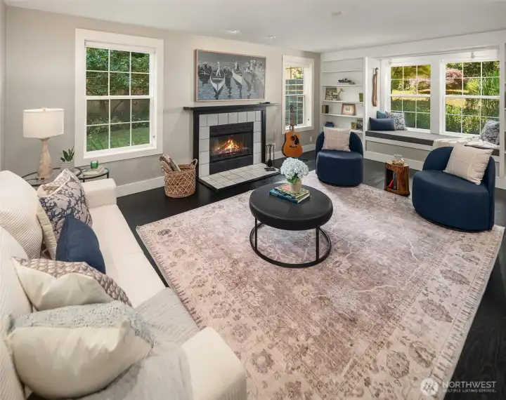 A cozy fireplace insert, built-in bookshelves and window seat make this space welcoming. A cozy fireplace insert, built-in bookshelves and window seat make this space welcoming.