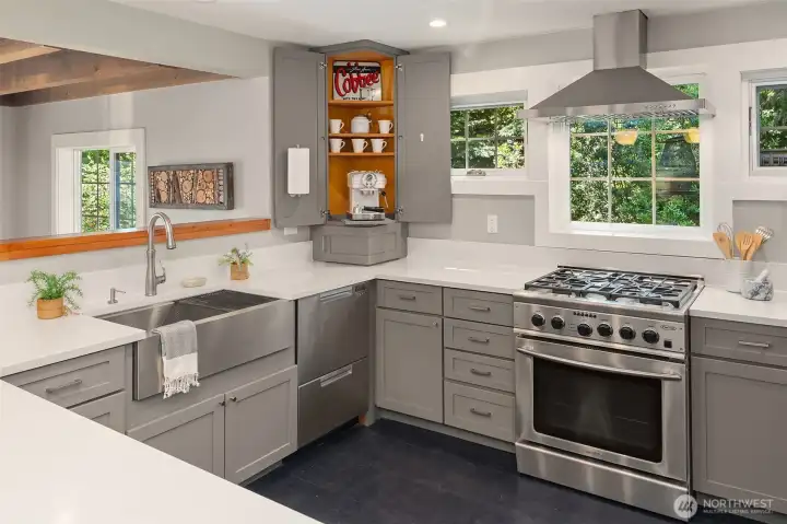 A corner coffee cupboard, in-counter compost bin, and dual drawer dishwasher. A corner coffee cupboard, in-counter compost bin, and dual drawer dishwasher.